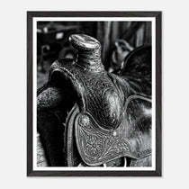 Black and white close up of a western saddle with worn leather and detailed craftsmanship, ranch wall art.