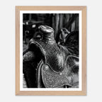 Black and white close up of a western saddle with worn leather and detailed craftsmanship, ranch wall art.