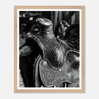 Black and white close up of a western saddle with worn leather and detailed craftsmanship, ranch wall art.