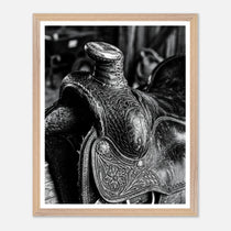 Black and white close up of a western saddle with worn leather and detailed craftsmanship, ranch wall art.