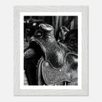Black and white close up of a western saddle with worn leather and detailed craftsmanship, ranch wall art.