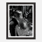 Black and white close up of a western saddle with worn leather and detailed craftsmanship, ranch wall art.