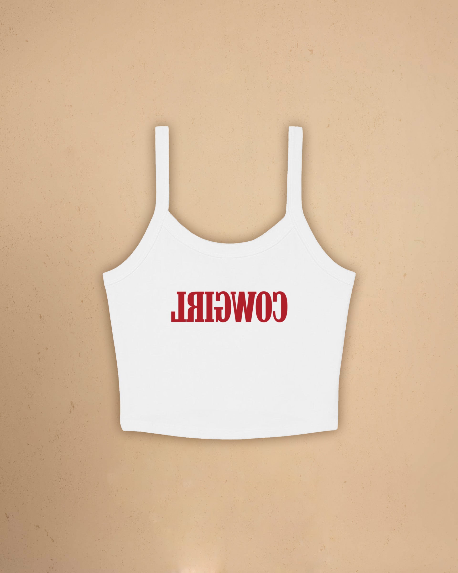 Fitted western-inspired strap tank top featuring mirrored “Cowgirl” typography on the front with a soft micro rib silhouette.